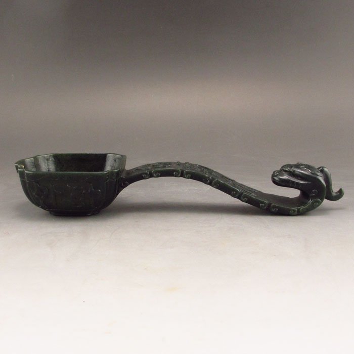 Chinese Deep Green Hetian Jade Dragon Head Scoop Statue: Hand Carved Chinese Natural Deep Green Hetian Jade Dragon Head Scoop Statue Dimension:200*60*30(mm)7.87*2.36*1.18(in)Weight 0.29 lbs/130 gTips about Chinese Hetian Nephrite Jade Hetian jade is a nephr