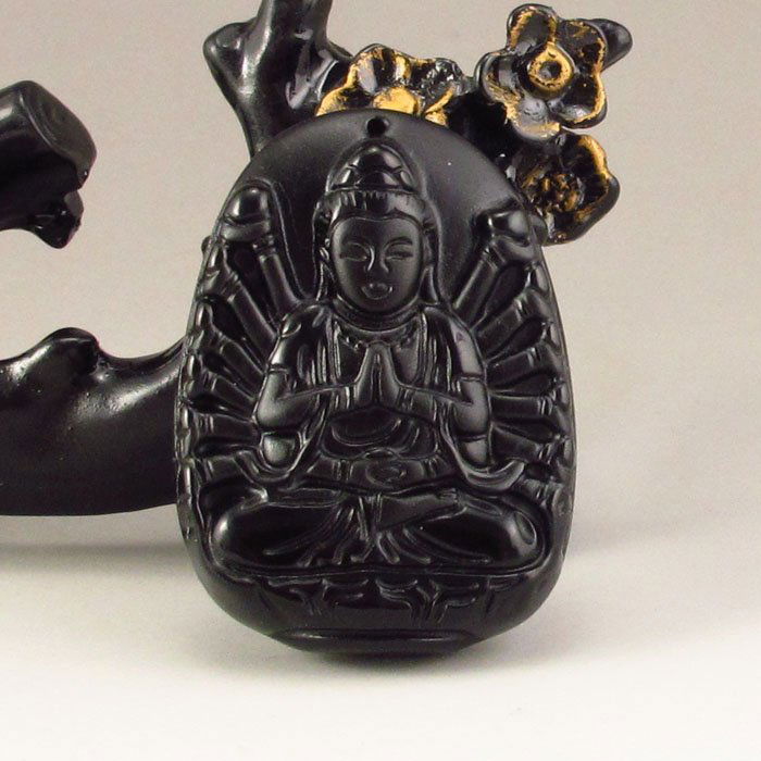 Chinese Obsidian Pendant -Thousands Hands Guanyin: Chinese Natural Obsidian Pendant - Thousands Hands GuanyinDimension: 36*50*14(mm) 1.42*1.97*0.55(in) Weight 0.08 lbs/35g The total weight does not include the base. The base is not included after you