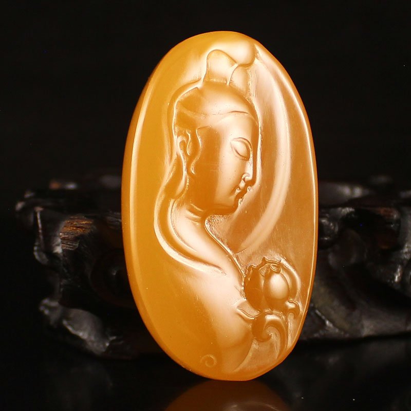 Indonesia Natural Jin Tian Huang Pendant - Kwan-yin: Beautiful Color Indonesia Natural Jin Tian Huang Pendant - Kwan-yin Dimension: 59*33*11(mm) 2.32*1.30*0.43(in) Weight 0.10 lbs/46 g Jin Tian Huang from Indonesia and Java Sun Xi, the stone in the unpr