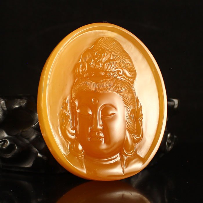Indonesia Jin Tian Huang Kwan-yin Pendant: Indonesia Jin Tian Huang Kwan-yin Pendant Dimension:84*71*16(mm) 3.31*2.80*0.63(in) Weight 0.44 lbs/199 g Jin Tian Huang from Indonesia and Java Sun Xi, the stone in the unprocessed, looks like a soap
