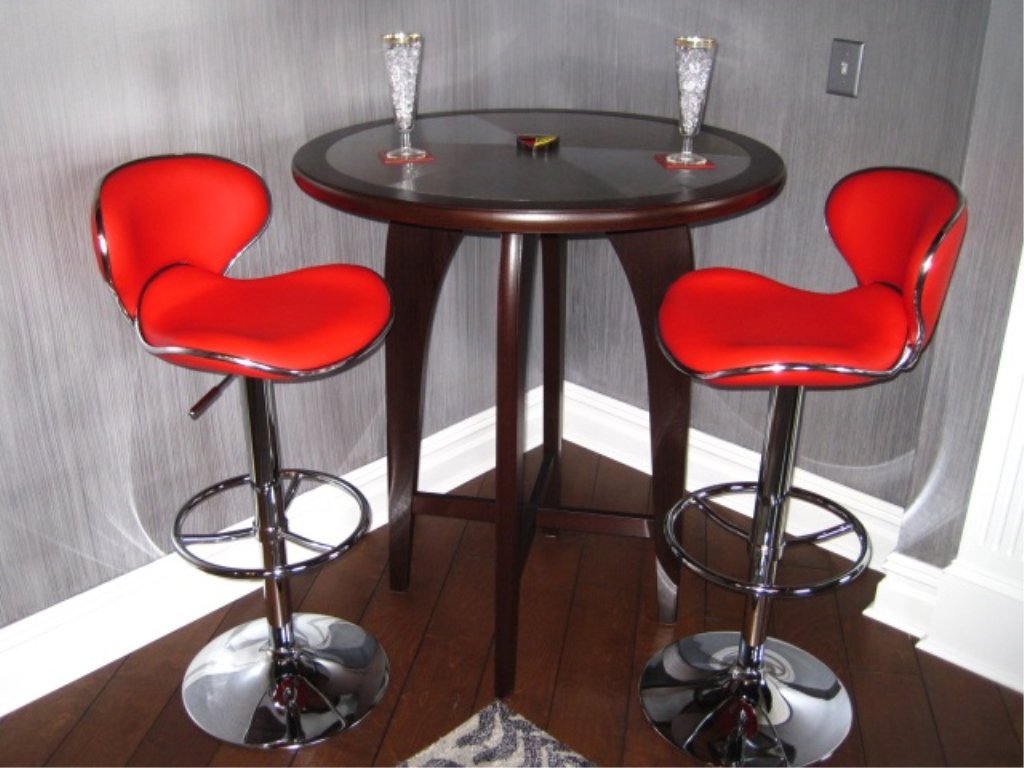 Pair Chintaly Greenwich Adjustable Swivel Barstool: Red leather and chrome. Sold by the pair. Wenge cocktail table not included.