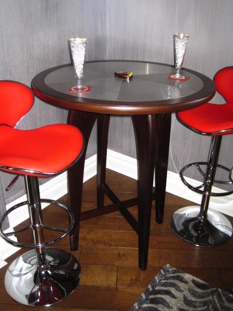 Custom Wenge Cocktail Table: Designed by Suzanne Pfister, Crafted by Howard Hatch to Coordinate with Billiard Table. Natural Wenge. Stainless Steel "Wheel" Top with Porsche Crest. '40" tall x 35 1/2" diameter. Chairs and glasswar