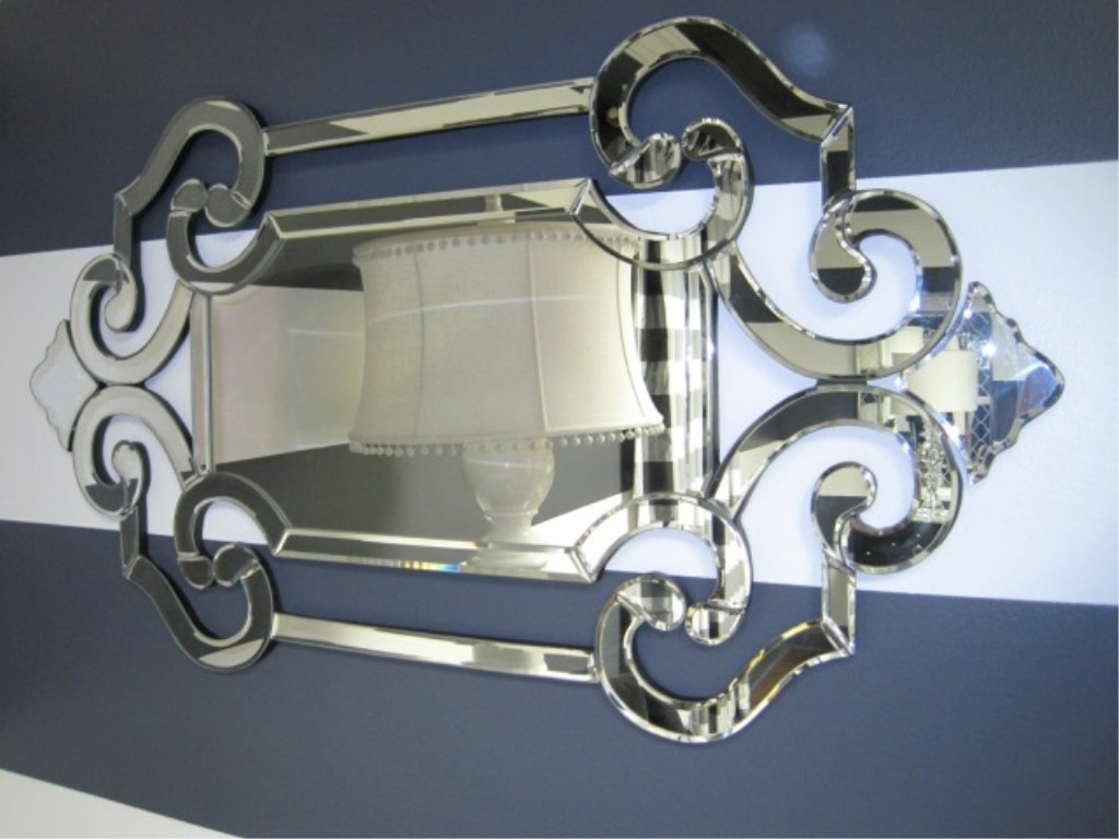 Venetian Glass Mirror: Big, bold scrolls, all in mirrored glass, create a grand look for any room. Crafted by hand. 22" wide x 1" deep x 41" tall.