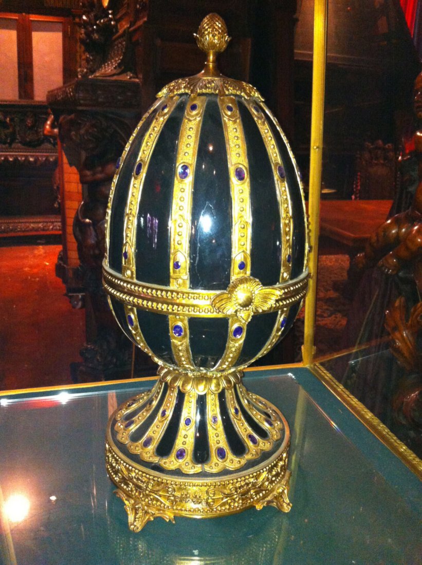 One of a Pair of Palatial Porcelain and Bronze Egg: Amazing large porcelain egg with bronze foot and cladding. Has hand cut stones inlaid throughout. 10" W x 23" H