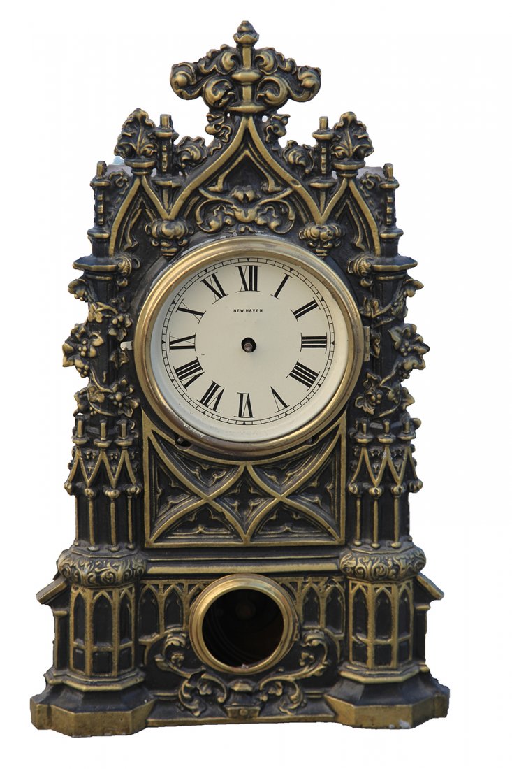 New Haven Heavily Decorated Bronze Mantle Clock: Heavily Decorated Bronze Faced and Wood Backed clock Dimensions: 18.25" H x 11" W