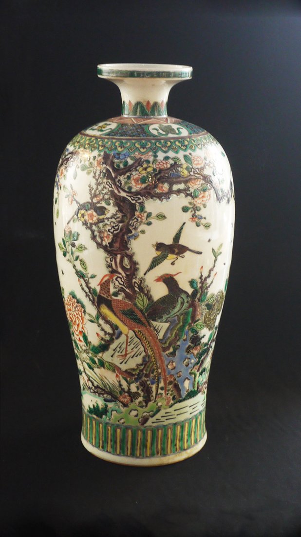 A MAGNIFICENT YONGZHENG TALL VASE: with a slight tapering body rising to a round shoulder beneath a short waited neck with striaght rim, the exterior applied overall with Famille Vert decoration of songbirds and blossoms above tight ba