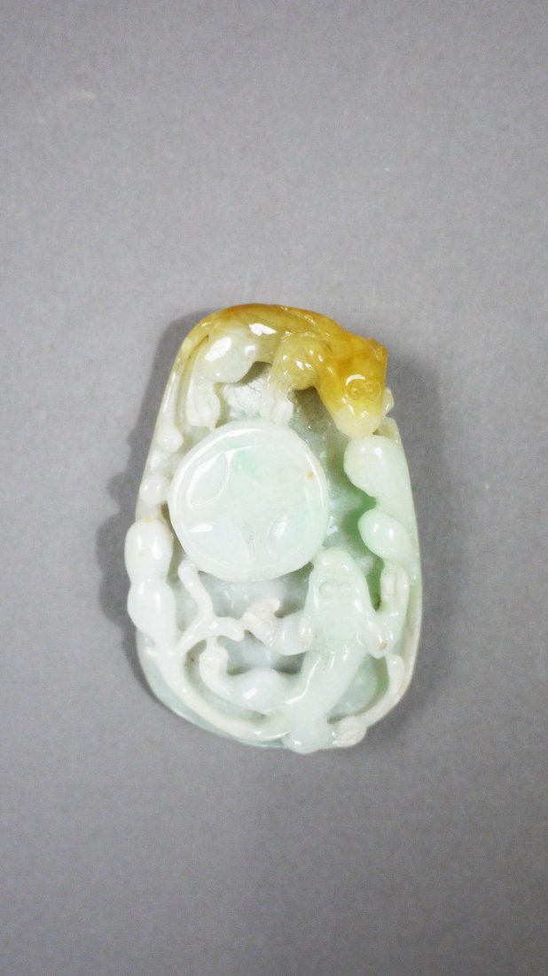 Jadeite Pendant: (Jadeite Pendant) Colour: light green and yellow Size:5.1 x 3.4 Weight: 33g. Fine Chinese jade carved in irregular ellipse pendant, featuring bufonid design on front and archaic designs on top and bot