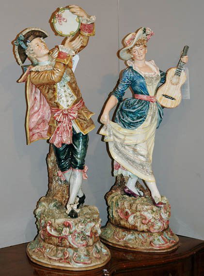 Pair of Continental Glazed Ceramic Figures: Pair of Continental Glazed Ceramic Figures Modeled as a male or female musician in a standing pose, on a naturalistic oval base. Height of taller 32 inches.