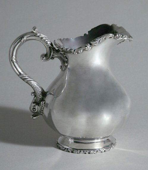 American Sterling Silver Water Pitcher: American Sterling Silver Water Pitcher Duhme & Co., Cincinnati, early 20th century Having a lobed body, foliate rim and a scrolling handle chased with a dolphin, marked Duhme & Co./ Sterling Silver/ C