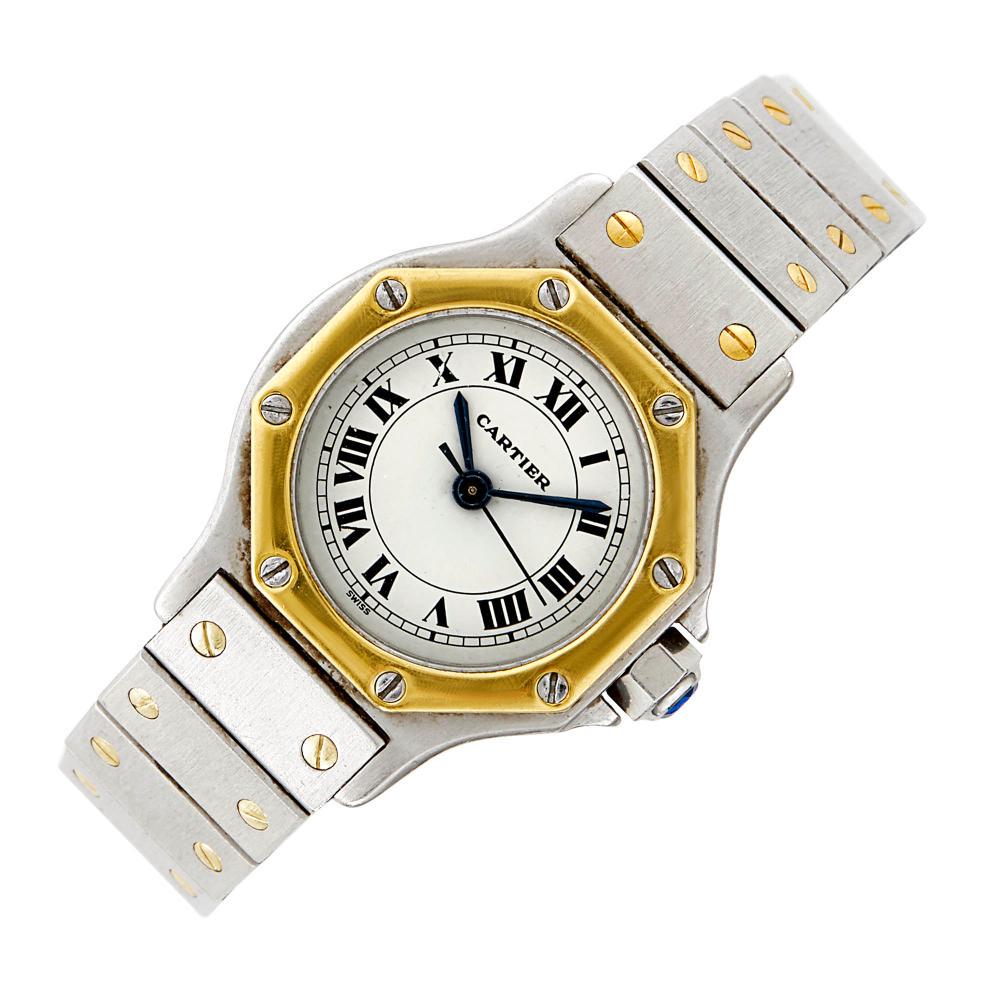 Cartier Stainless Steel and Gold 'Santos' Wristwatch: Cartier Stainless Steel and Gold 'Santos' Wristwatch 18 kt., automatic, centering a circular white dial with black Roman numerals, sweep seconds, dia. ap. 24 mm., with a gold screw-down bezel, complet