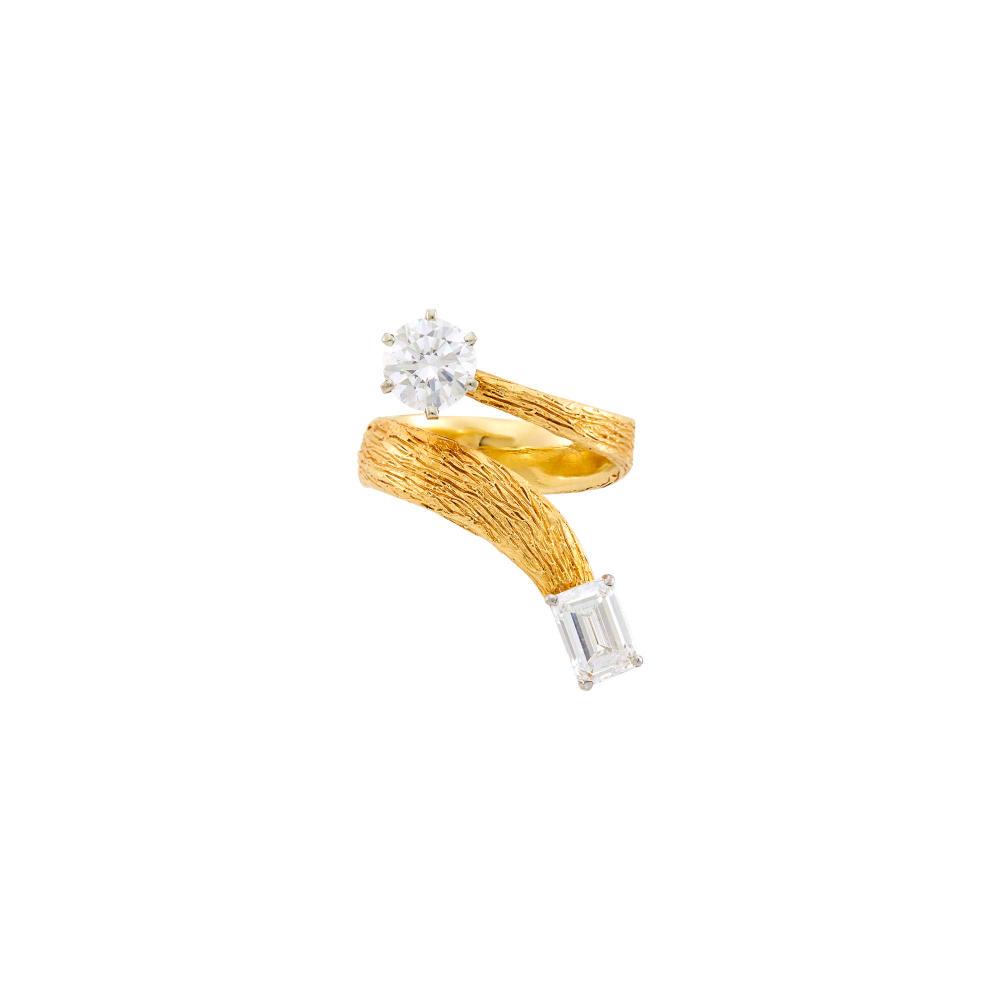 Ed Wiener Gold and Diamond Bypass Ring: Ed Wiener Gold and Diamond Bypass Ring 14 kt., the bark-textured gold flares set with one round diamond ap. 1.10 cts., and one emerald-cut diamond ap. .90 ct., with obscured maker's mark, ap. 5 dwts.