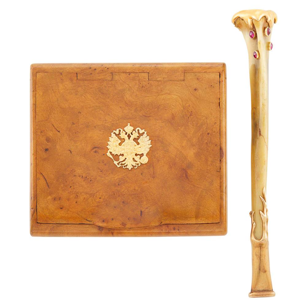 Verdura Gold, Bone and Cabochon Ruby Cigarette Holder: Verdura Gold, Bone and Cabochon Ruby Cigarette Holder and Russian Burled Wood and Gold Cigarette Box The tapered bone cigarette holder embellished by 5 collet-set round cabochon rubies, capped by gold