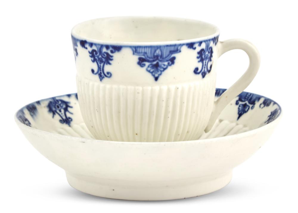 Saint Cloud Porcelain Blue and White Cup and Socketed: Saint Cloud Porcelain Blue and White Cup and Socketed Saucer (Tasse Trembleuse et Soucoupe) Circa 1730, blue t / S o C / T marks to the cup and saucer, II / D to cup The gadrooned cup and socketed sau