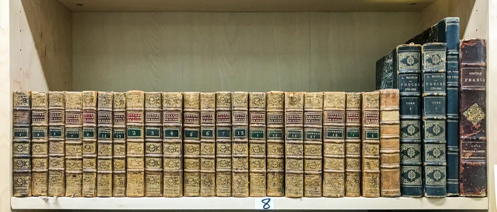 [BINDINGS] Group of approximately one hundred: [BINDINGS] Group of approximately one hundred seventy-five leather bound books. Mostly works in French in half or three-quarters morocco gilt. Includes a partial set of the Oeuvres Completes de M. Le