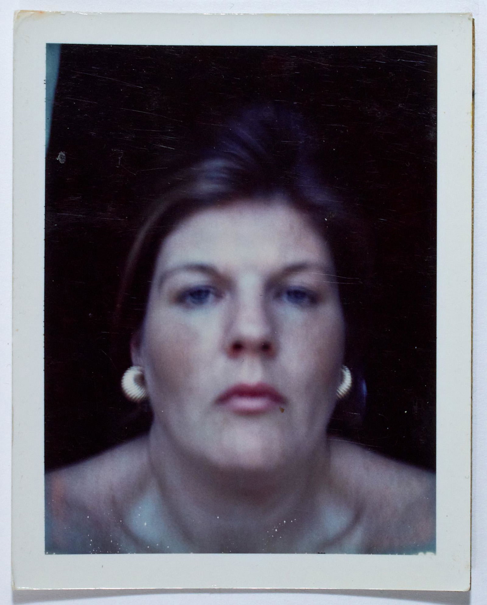 BRIGID BERLIN Two signed Polaroid self portraits.: BRIGID BERLIN Two signed Polaroid self portraits. Two vintage color Polaroids, likely late 1960s, the first depicting Berlin nude from the waist up, the second a close up self portrait, both signed or
