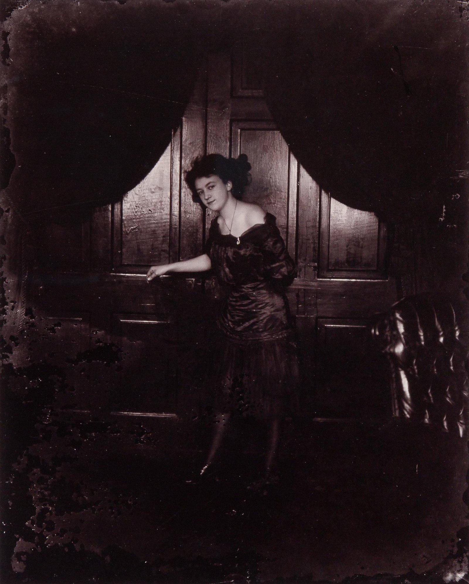 BELLOCQ, E. J. (1873-1949) [Storyville portrait, New Orleans, woman standing before paneling], circa: BELLOCQ, E. J. (1873-1949) [Storyville portrait, New Orleans, woman standing before paneling], circa 1900. 10 x 8 inches (252 x 204 mm), printed later by Lee Friedlander using gold chloride on printin