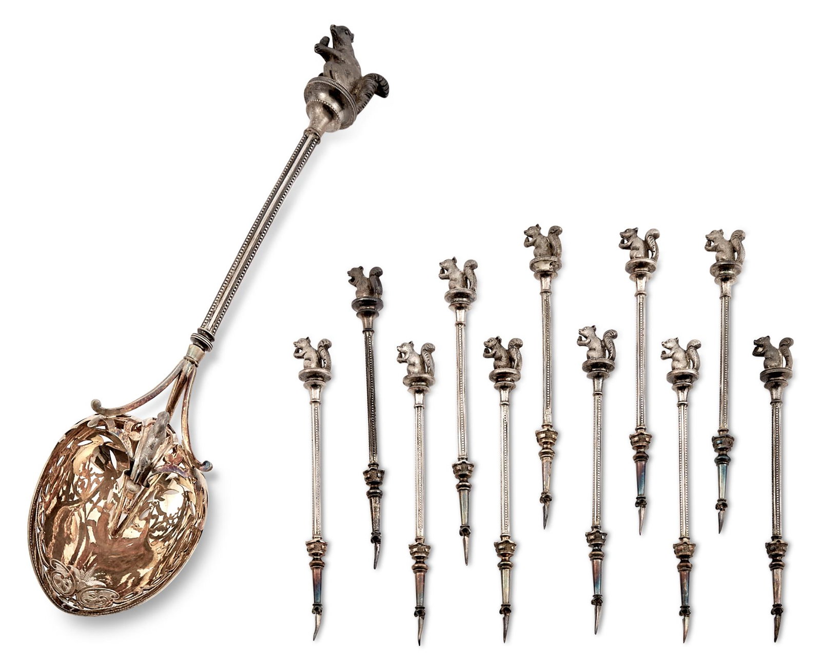 George Sharp Silver Cased Nut Set Retailed by Tiffany & Co., 1860s Comprising a hooded serving spoon: George Sharp Silver Cased Nut Set Retailed by Tiffany & Co., 1860s Comprising a hooded serving spoon and eleven individual nut picks, each with a cast squirrel finial. Length of spoon 10 1/4 inches, l