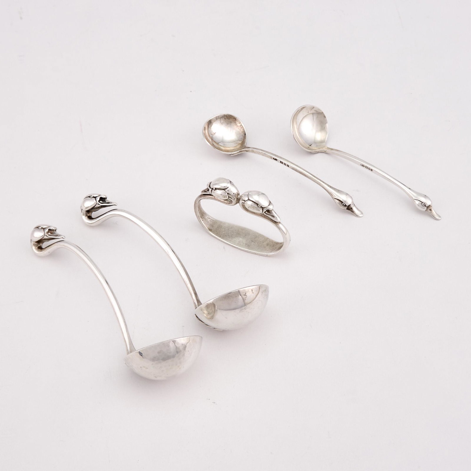 Group of Elizabeth II Sterling Silver Novelty Serving Pieces: Group of Elizabeth II Sterling Silver Novelty Serving Pieces Sarah Jones, London, 1983/1984 Comprising a pair of sauce ladles, pair of sugar spoons and a napkin ring, each with a cast duck's head term
