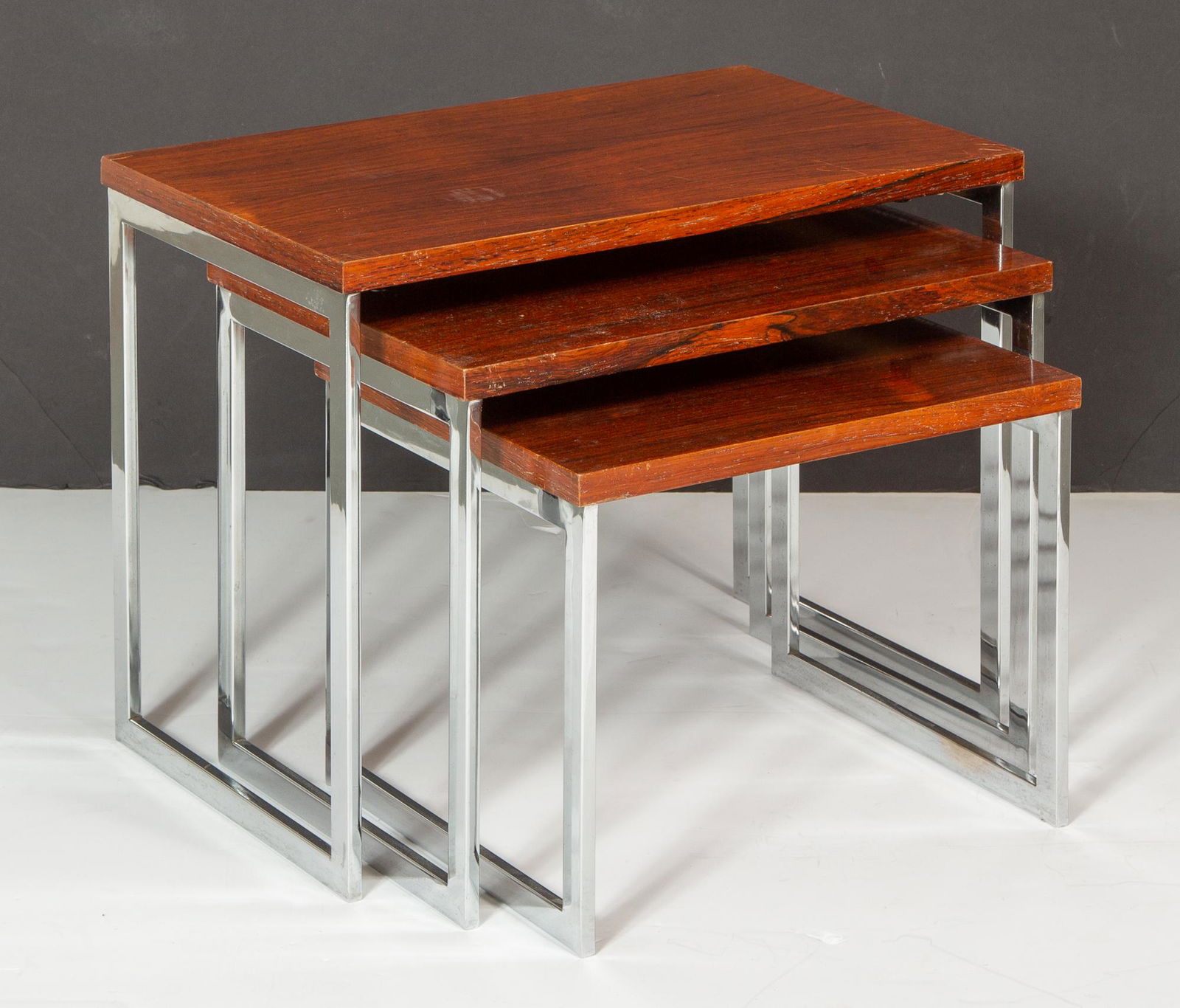 Nest of Three Danish Rosewood and Chromed Metal Tables: Nest of Three Danish Rosewood and Chromed Metal Tables Severin Hansen, 1960s Each with a rectangular top. Height of largest 15 inches, length 19 3/4 inches, depth 12 inches. C