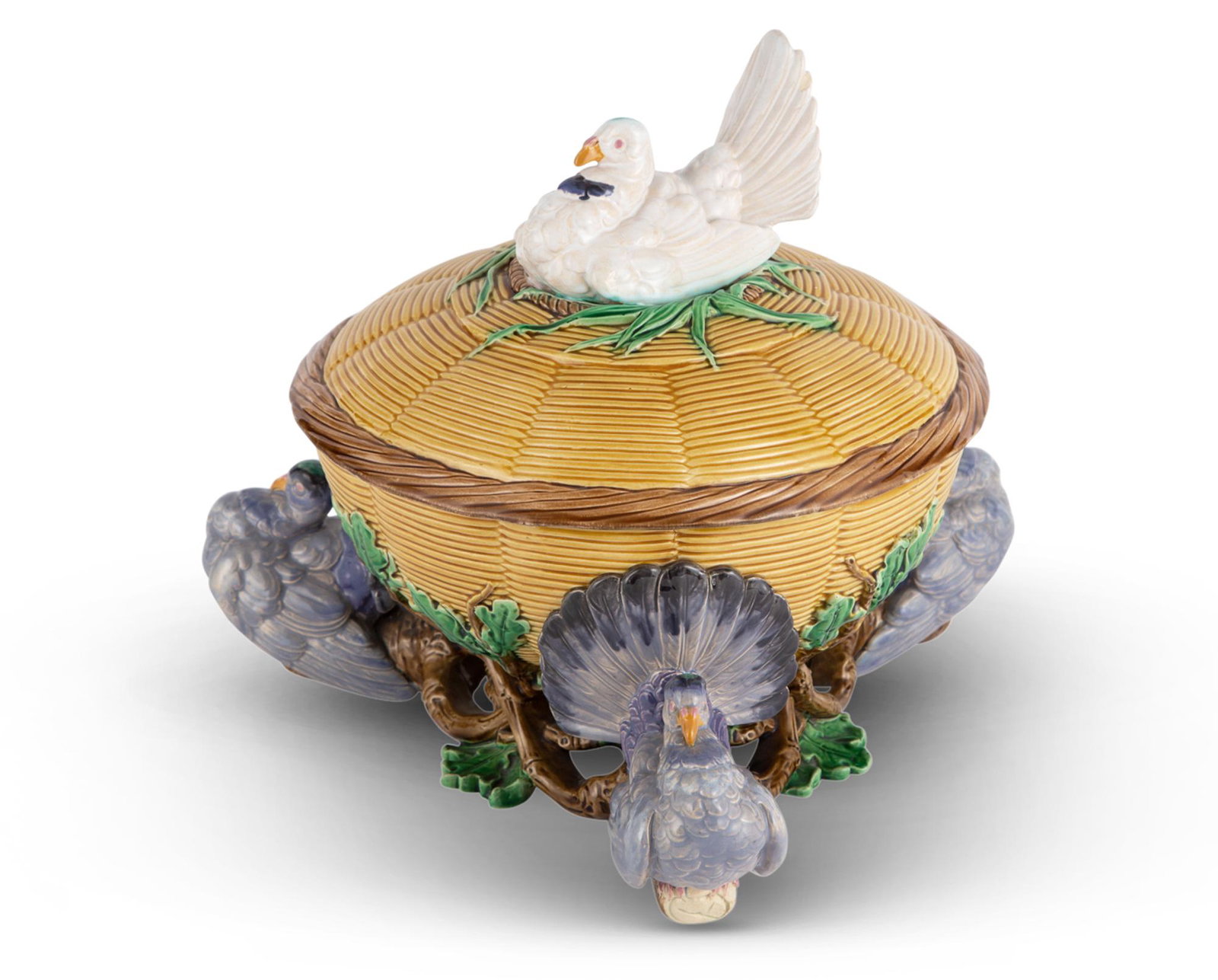 Minton Majolica 'Pigeon Pie' Tureen and Cover Shape no. 777, date cypher for 1864 Molded as a: Minton Majolica 'Pigeon Pie' Tureen and Cover Shape no. 777, date cypher for 1864 Molded as a circular wicker bowl supported on the three fan-tailed gray pigeons resting among entwined oak branches, t