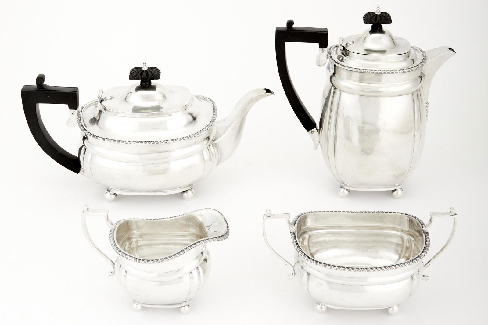 George V Sterling Silver Tea and Coffee Service: George V Sterling Silver Tea and Coffee Service Charles Stuart Harris, London, 1934 Comprising a teapot, coffee pot, cream jug and sugar bowl, each with gadrooned rim. Height of coffee pot 8 1/2 inche