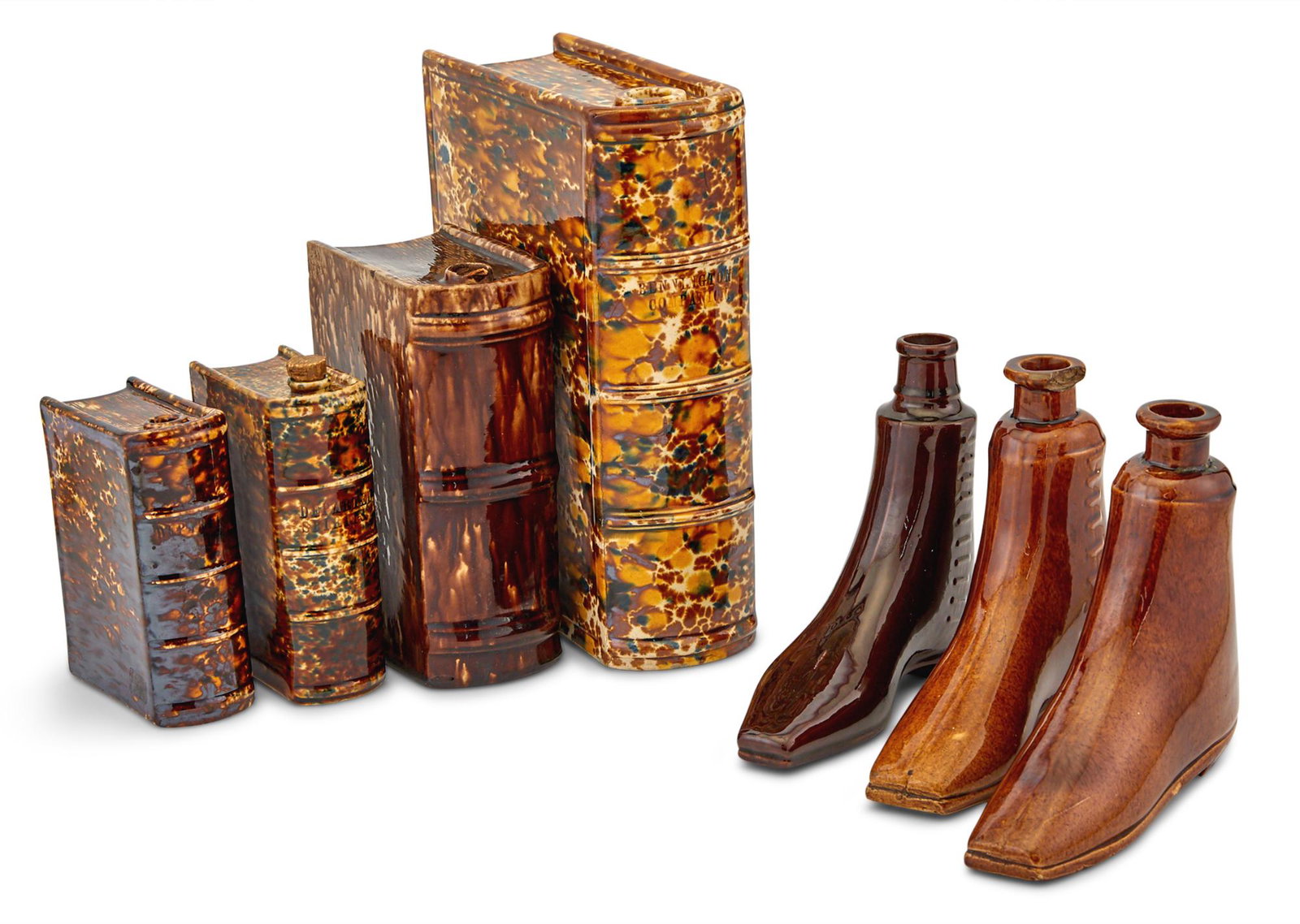 Seven Rockingham Glazed Pottery Flasks: Seven Rockingham Glazed Pottery Flasks America, mid to late 19th century comprising four book form of varying sizes, and three boot form, largest book form flask impressed "BENNINGTON COMPANION" on th