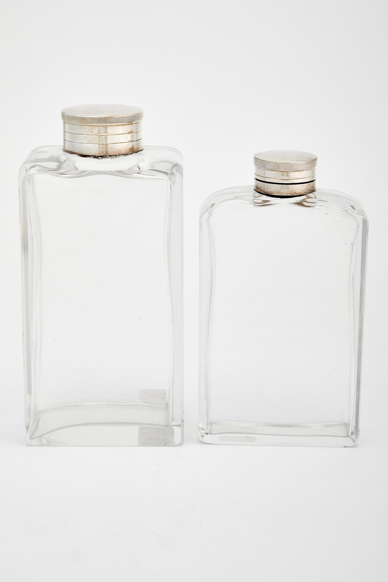 Two Silver Plate Mounted Glass Flasks: Two Silver Plate Mounted Glass Flasks Mid 20th century Heights 6 7/8 inches and 6 inches. C The Alice Kwartler Collection