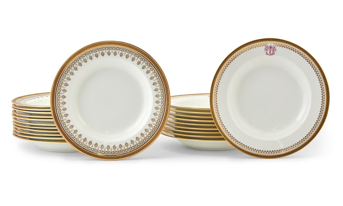 Two Sets of Gilt Decorated Porcelain Bowls: Comprising twelve Cauldon examples, diameter 10 1/4 inches; and ten examples with armorial, diameter 10 1/2 inches.