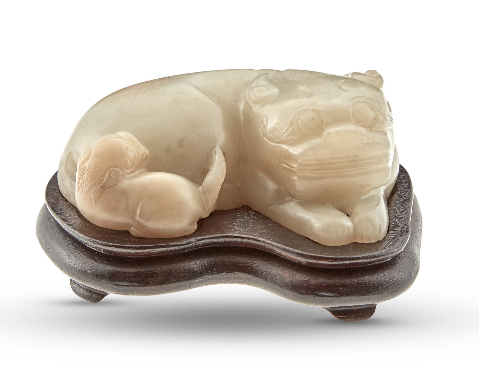 A Chinese Carved Jade Lion Ming-Qing Dynasty: Carved in the recumbent position; wooden base.