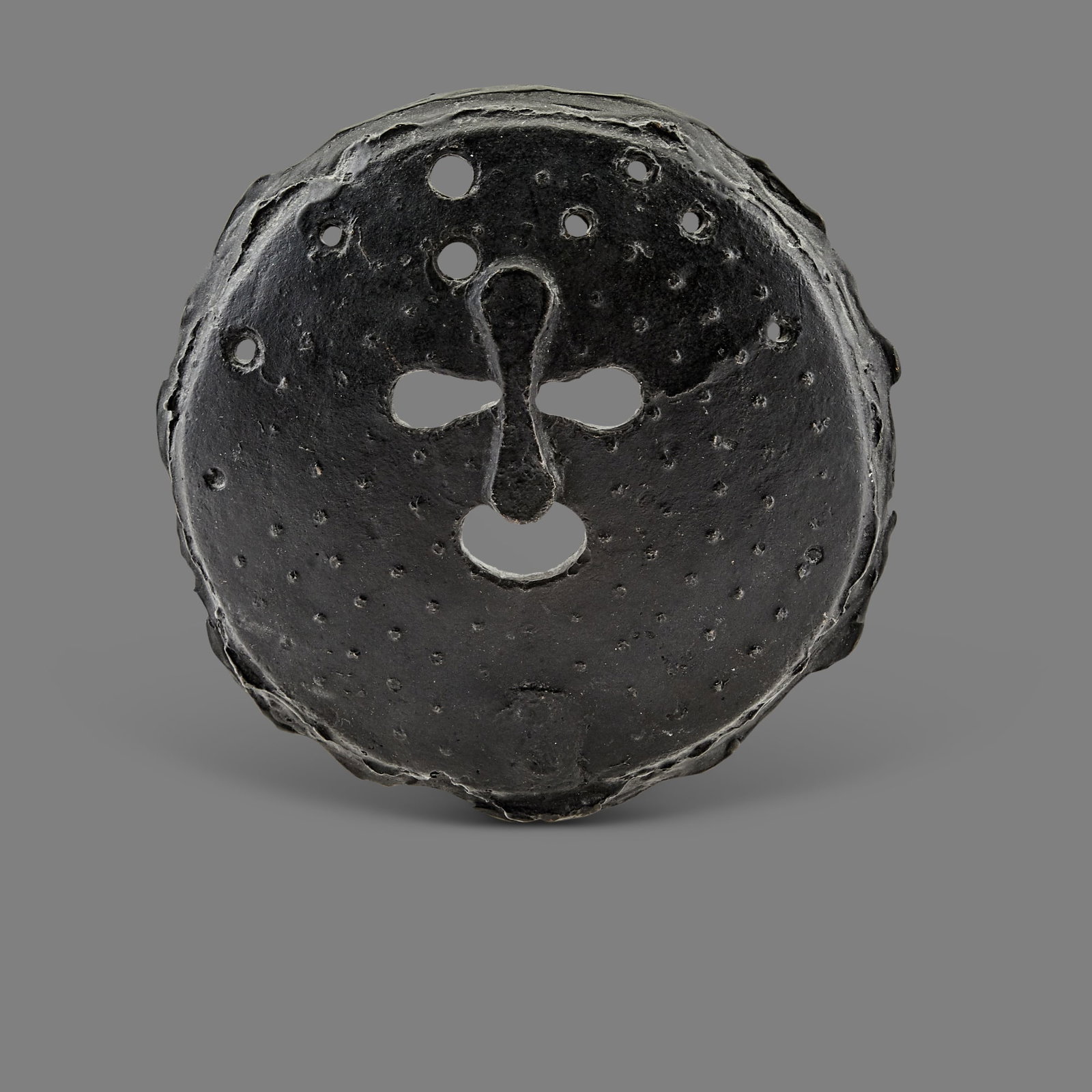 Robert Courtright: American, 1926-2012 Untitled Mask Signed and numbered Courtright 1/5 Bronze with black patina on lucite stand Mask 5 3/4 x 5 3/4 x 1/2 inches (14.6 x 14.6 x 1.2 cm), overall with stand 8 3/8 x 6 x 3 i