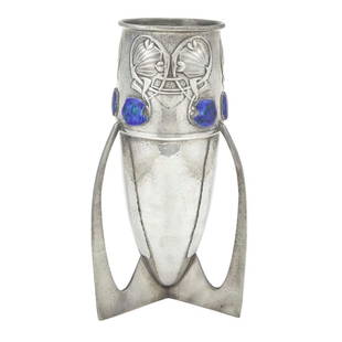 Archibald Knox for Liberty & Co. Pewter and Enamel Tudric Pattern Vase: Estate / Collection: Property from a Gold Coast Long Island Private Collection The bullet-form body decorated with an upper band of Celtic-insprired foliate motifs set with mottled cobalt blue and gre