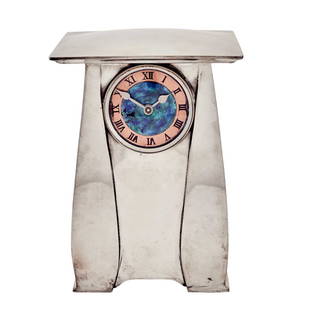 Archibald Knox for Liberty & Co. Pewter and Enamel Tudric Pattern Mantel Clock: Estate / Collection: Property from a Gold Coast Long Island Private Collection With a domed rectangular top above a conforming case enclosing a circular enamel dial with black Roman numerals. Height 7