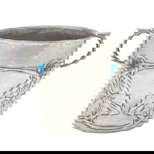 Archibald Knox for Liberty & Co. Pewter and Enamel Tudric Pattern Ice Bucket: Estate / Collection: Property from a Gold Coast Long Island Private Collection Of tapering cylindrical form with C-shaped handles, the body decorated with a band of Celtic-inspired stylized foliate mo
