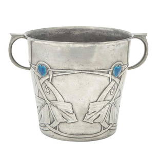 Archibald Knox for Liberty & Co. Pewter and Enamel Tudric Pattern Ice Bucket: Estate / Collection: Property from a Gold Coast Long Island Private Collection Of tapering cylindrical form with C-shaped handles, the body decorated with a band of Celtic-inspired stylized foliate mo