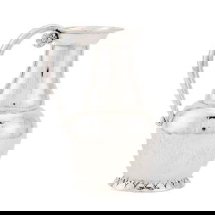 Georg Jensen Sterling Silver Pitcher: Estate / Collection: Property from a Gold Coast Long Island Private Collection Of baluster form with an oval foliate foot, the loop handle with rosette join. Height 6 3/4 inches, approximately 10 ounc
