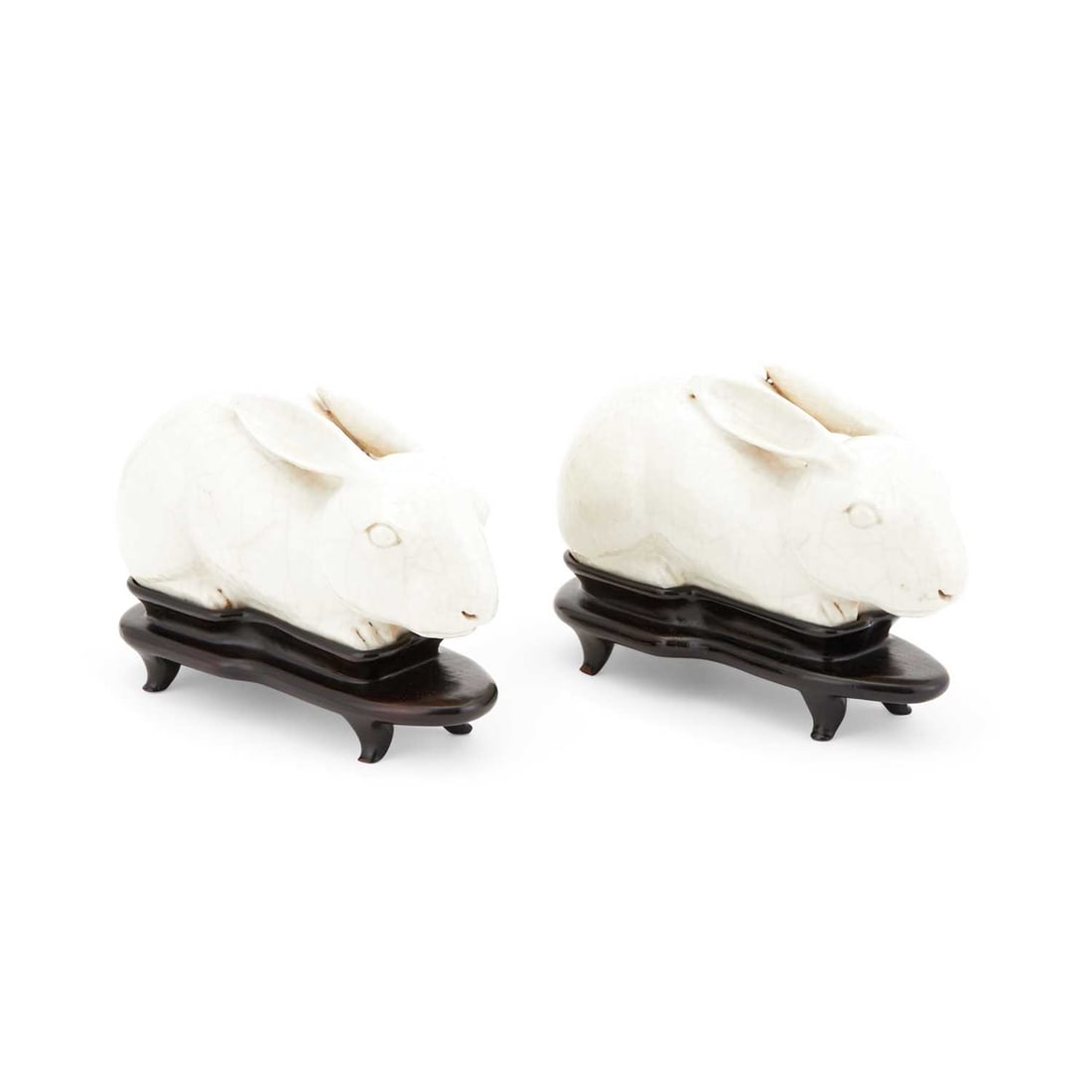 Pair of Chinese Porcelain Figures of Rabbits: Estate / Collection: Estate of Renee Meyers from a Manhattan Apartment Decorated by Albert Hadley Each on a custom wooden stand. Length 7 1/2 inches.