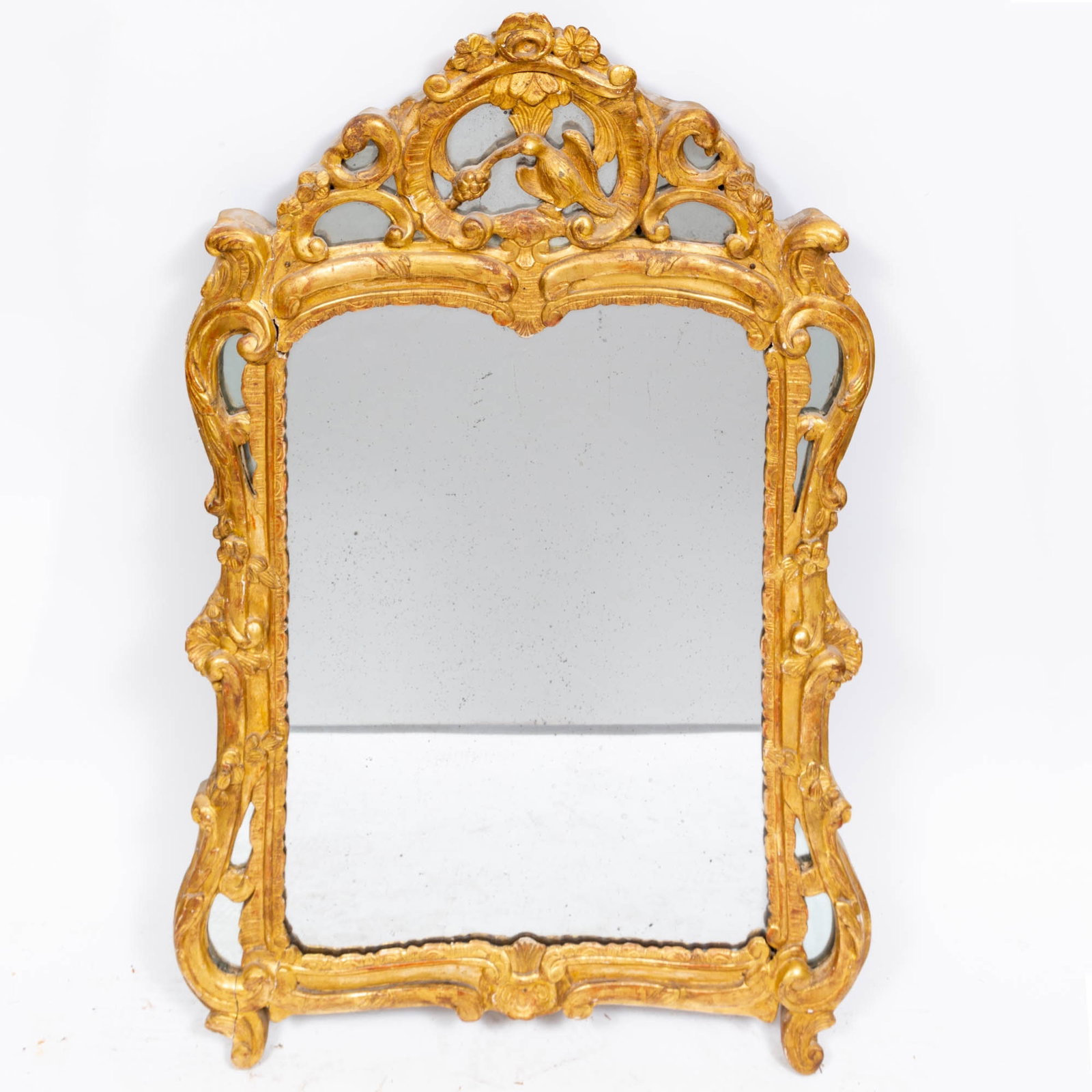 Louis XV Style Carved Giltwood Mirror: Estate / Collection: Estate of Renee Meyers from a Manhattan Apartment Decorated by Albert Hadley The shaped arched crest with scrolls and a bird. Height 42 inches, width 26 inches.