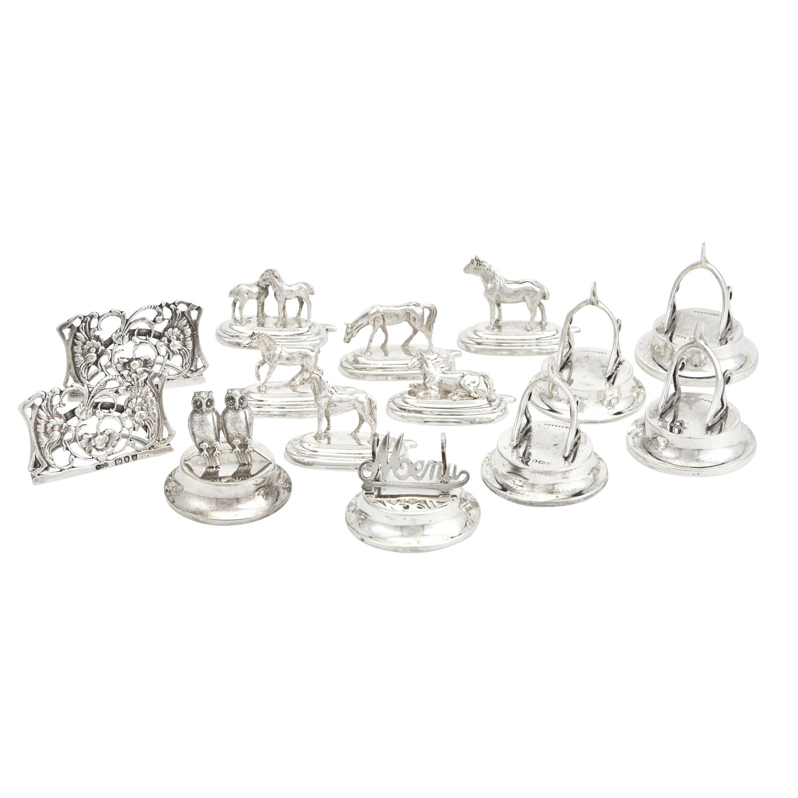 Group of Silver Menu and Place Card Holders 20th Century: Comprising:Set of Six Italian Examples with HorsesSet of Four English Examples with WishbonesPair of English Examples with Foliate ScrollsAn English Example "Menu"Total approximately 3 ounces, weighab