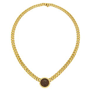 Bulgari Gold and Ancient Coin Curb Link Chain Necklace: 18 kt., reverse of frame engraved ROMA TITVS AVG. A.D. 79-81, clasp signed Bulgari, ap. 52.3 dwts. Length 16 1/2 inches. Frame diameter 3/4 inch. Chain width 1/4 inch.