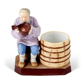 Russian Porcelain Figure of a Man Drinking from a Barrel
