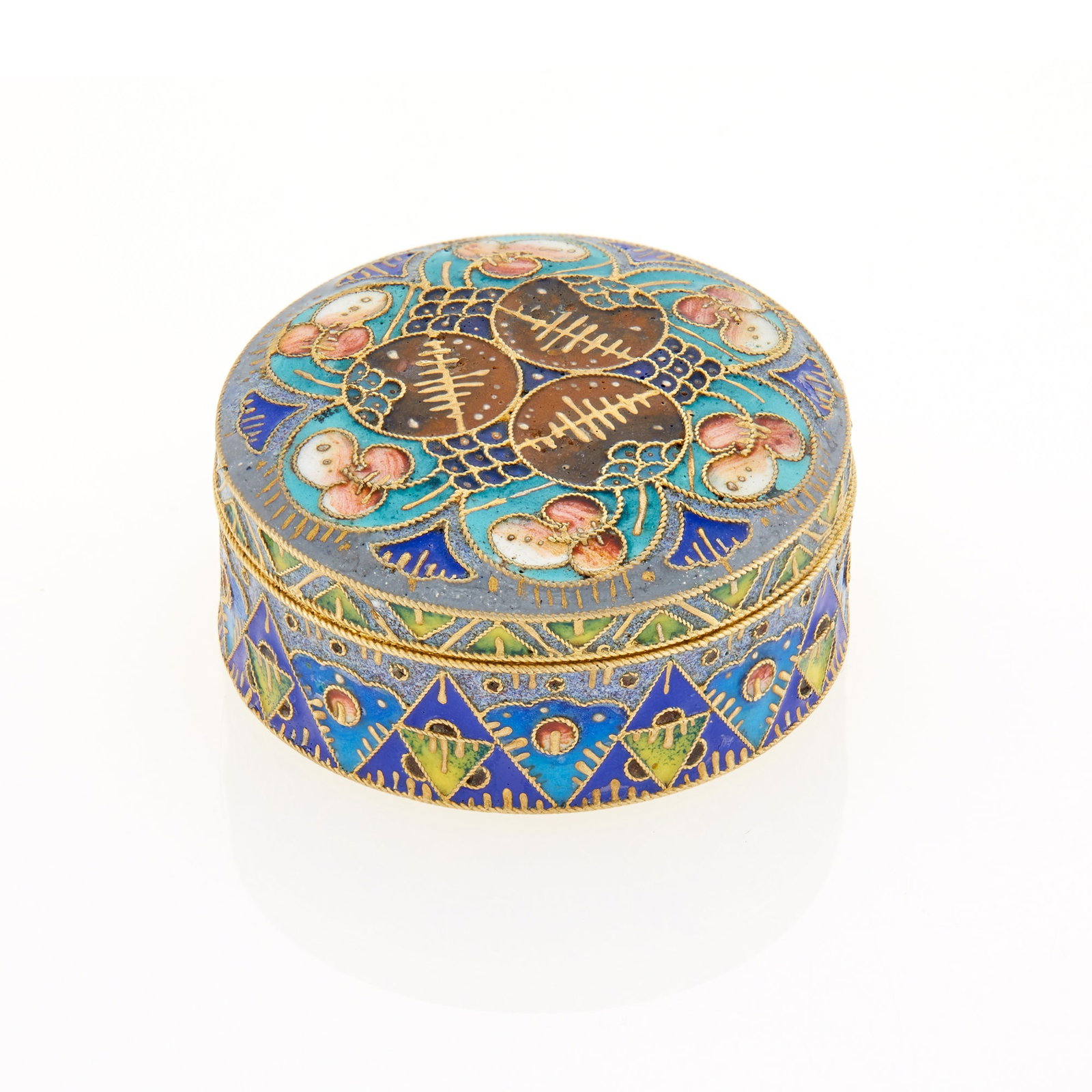 Russian Silver-Gilt and Cloisonné Enamel Pill Box: Maker's mark indistinct, Moscow, 1908-1917 Circular, with removable cover, enameled with varicolored shaded foliage and geometric motifs on blue grounds. Diameter 1 3/4 inches (4.5 cm).