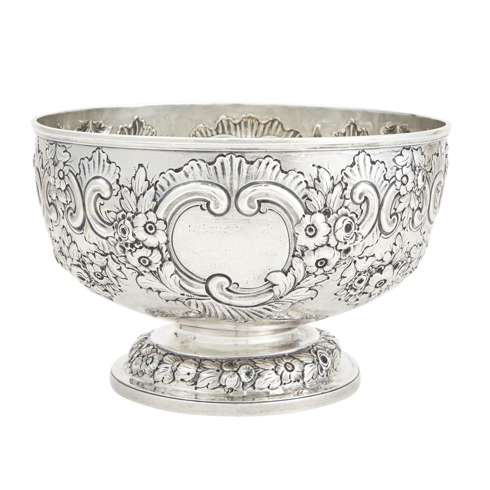 Victorian Sterling Silver Centerpiece Bowl Charles Stuart Harris, London, 1900: Of circular form, chased with scrolls and floral swags. Diameter 9 1/2 inches (24 cm), approximately 26 ounces. Erasures to each cartouche; the interior with dents to bottom and showing foot mar