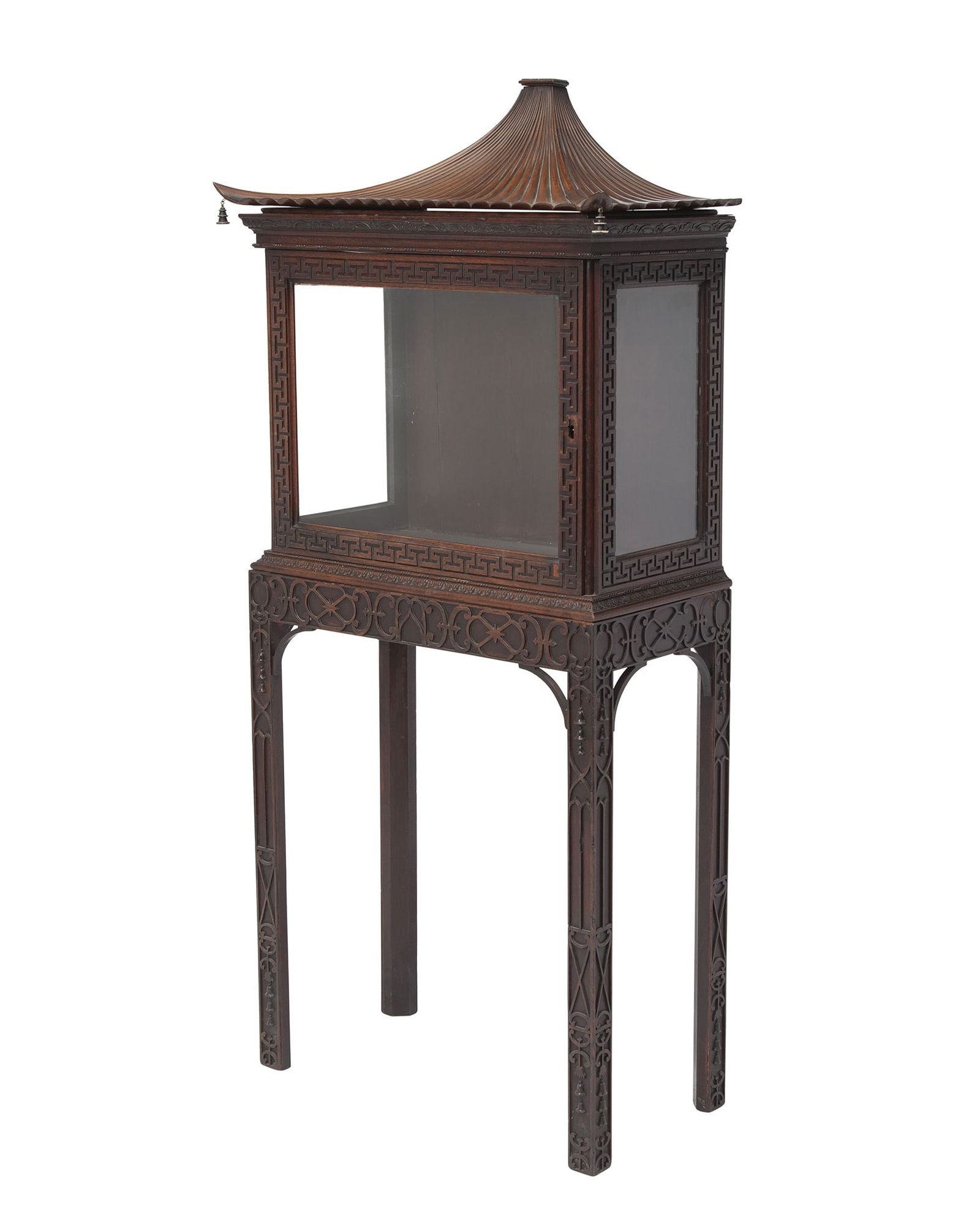 George II Style Mahogany Display Cabinet on Stand: After a design by Thomas Chippendale, the pagoda top hung with corner bells above a glazed door and sides within Greek key borders and formerly opening to a shelved interior, the stand with blind-fret