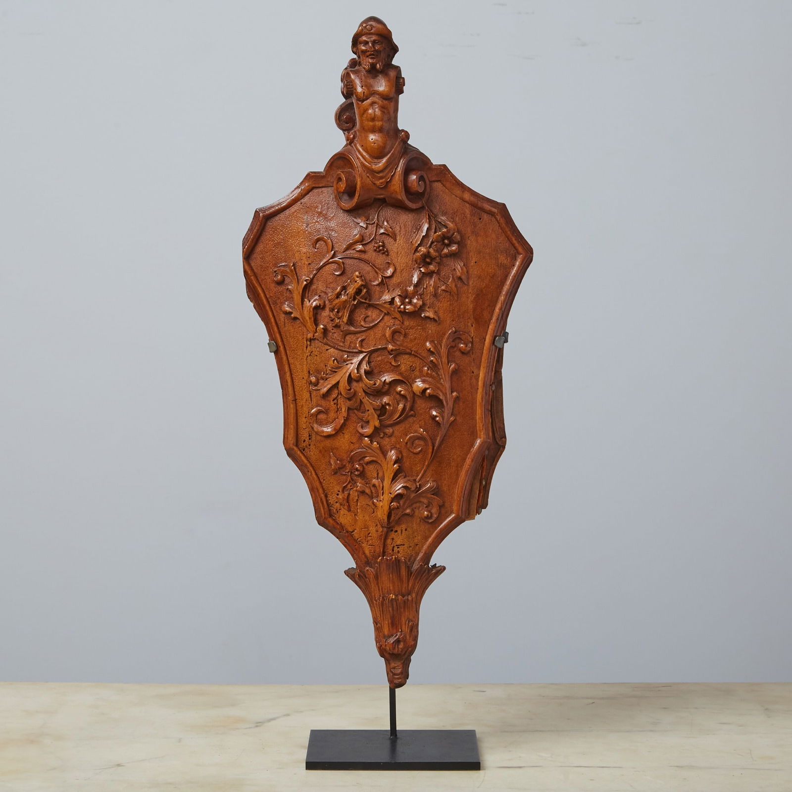 Louis XV Carved Walnut Bellows Circa 1735: The handle in the form of a male torso positioned above a panel carved with acanthus motifs and scrolls with a dragon head, the rear panel carved a mascaron, whose mouth serves as the intake hole. Hei