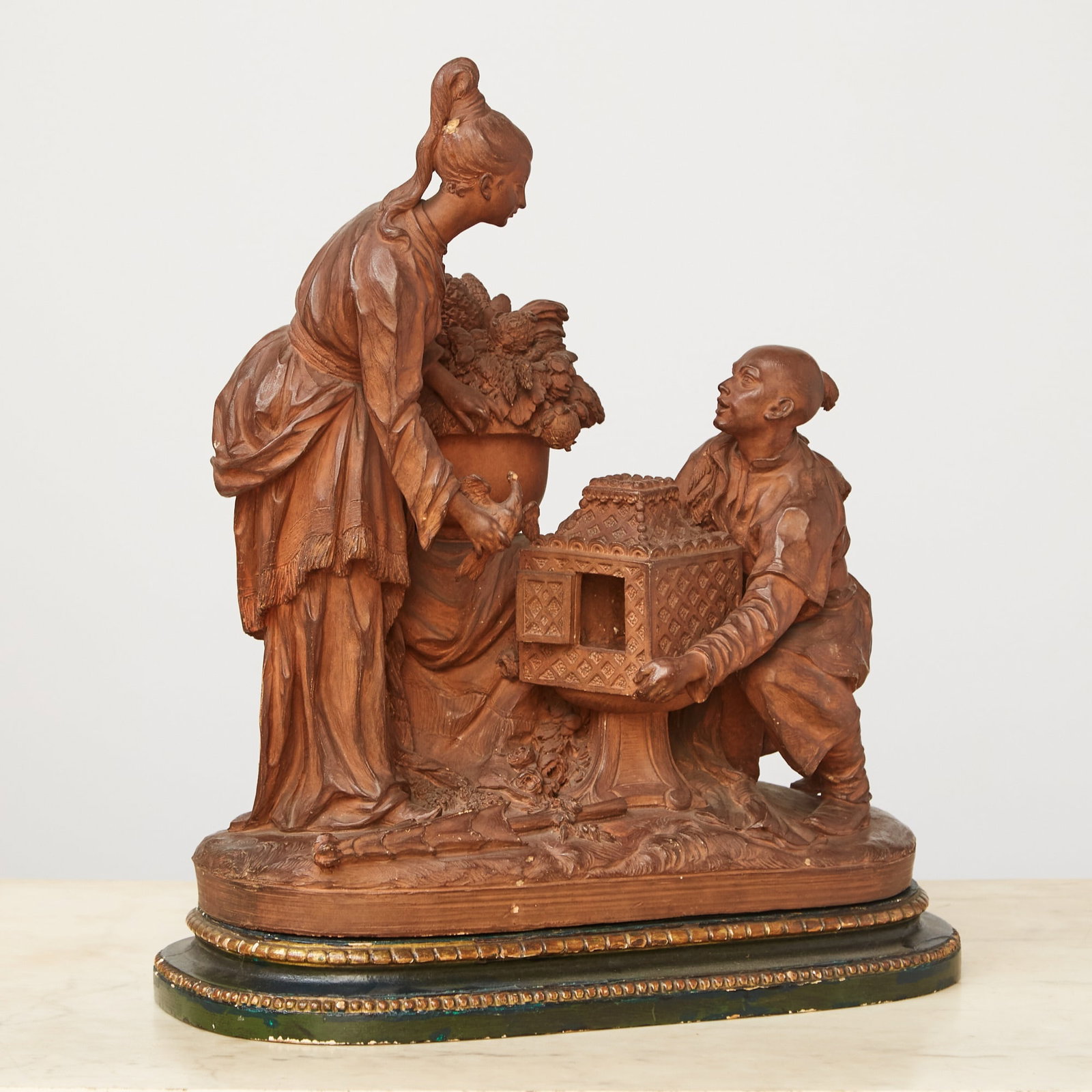 French or Belgian Terracotta Chinoiserie Sculpture of a Woman with a Bird 19th Century: Attributed to Andree Oda Marchal. Height 16 inches, width 14 inches, depth 7 inches.