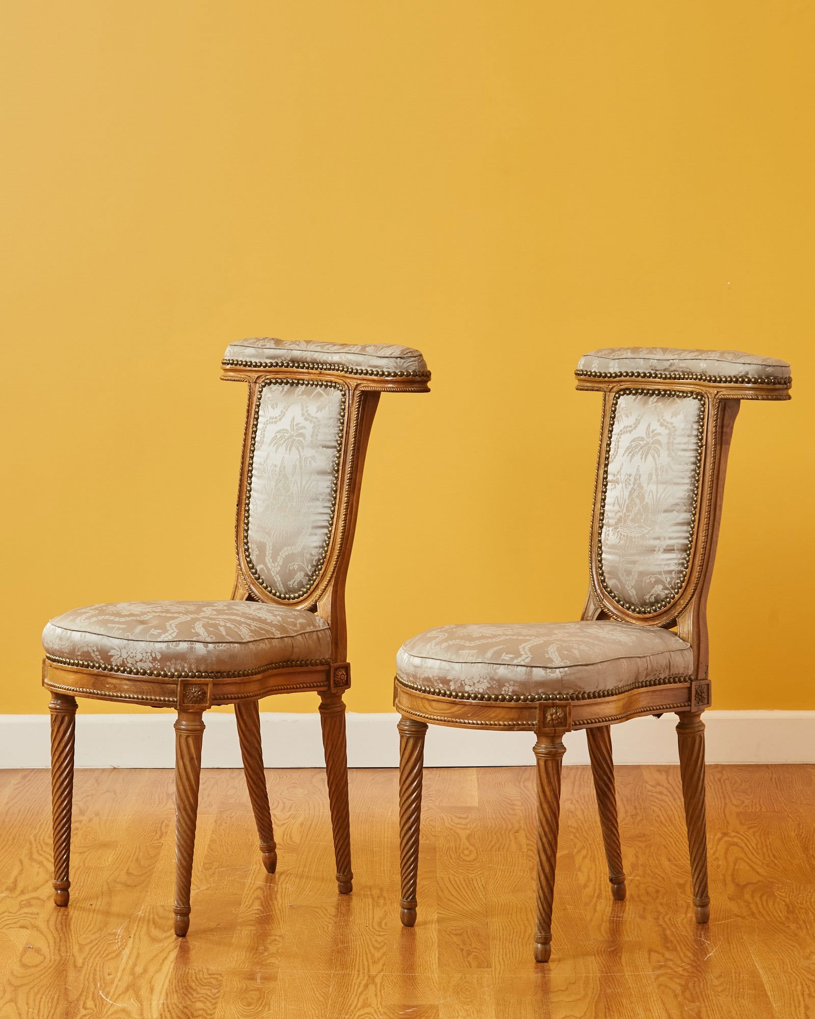 Pair of Louis XVI Walnut Chaises Ponteuses 18th Century: With twisted legs. Chairs of this form were used to watch games. Men would sit facing the back and rest their arms on the back crosspiece. Height 36 1/2 inches, width 18 1/2 inches, depth 19 inches; s