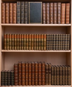 A large collection of books, finely bound in green and blue leathers