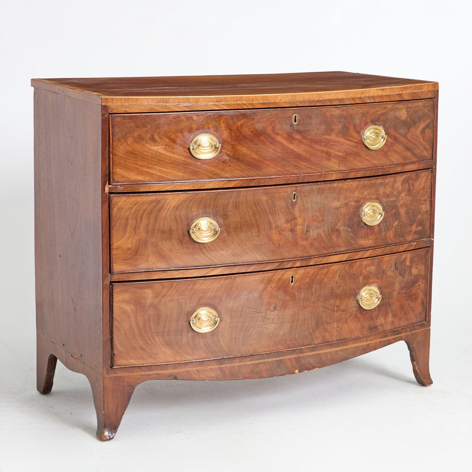George III Style Inlaid Mahogany Chest of Drawers: Height 33 1/2 inches, width 38 3/4 inches, depth 21 inches. veneer patches to top; veneer cracking, losses and replacements; cracks and sunfading to top; plugged holes to sides; veneer losses th
