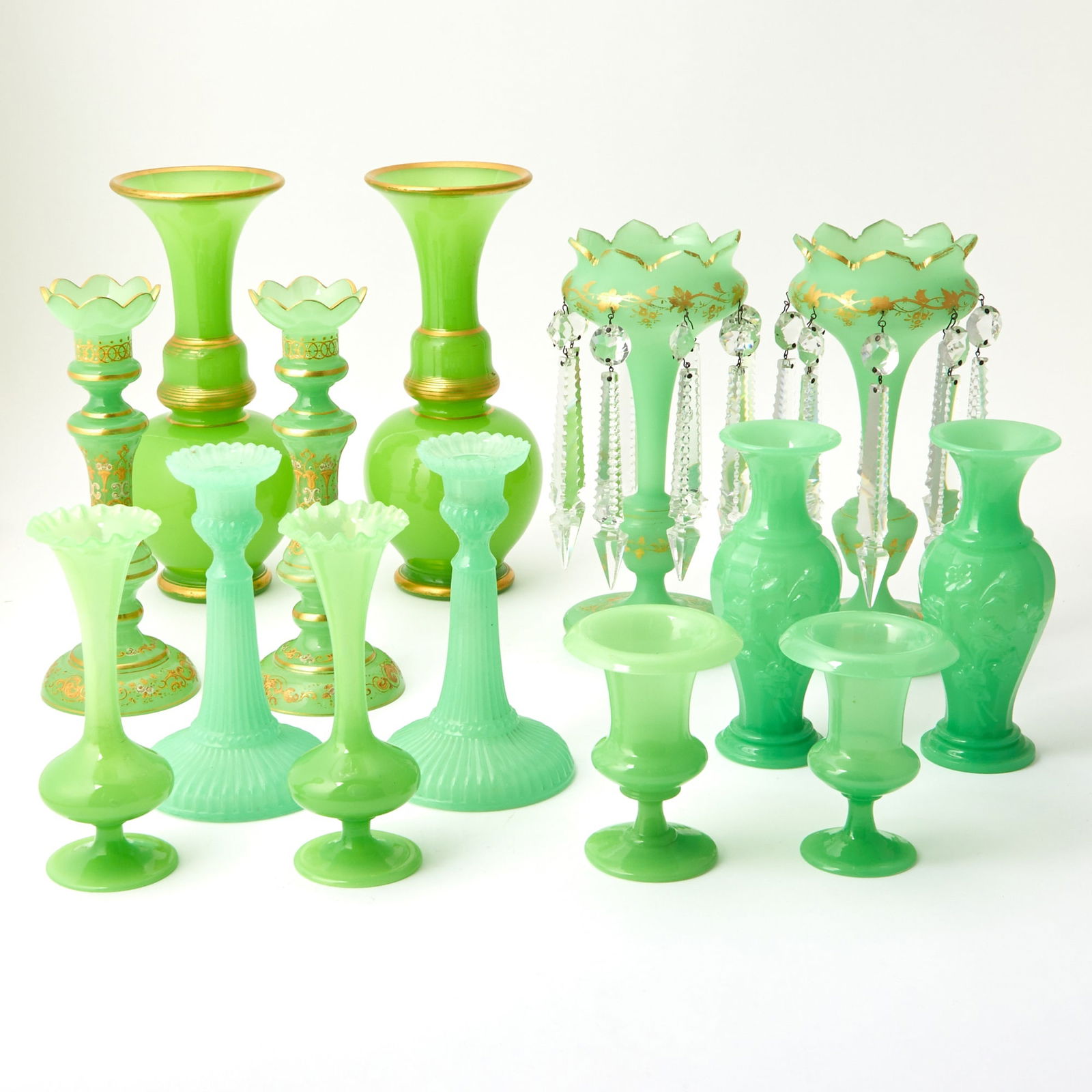 Group of Seven Pairs of Green Opaline Glass Vases and Candlesticks: Height of largest pair 12 inches; height of smallest pair 5 1/4 inches high. Some wear to gilding otherwise good condition.
