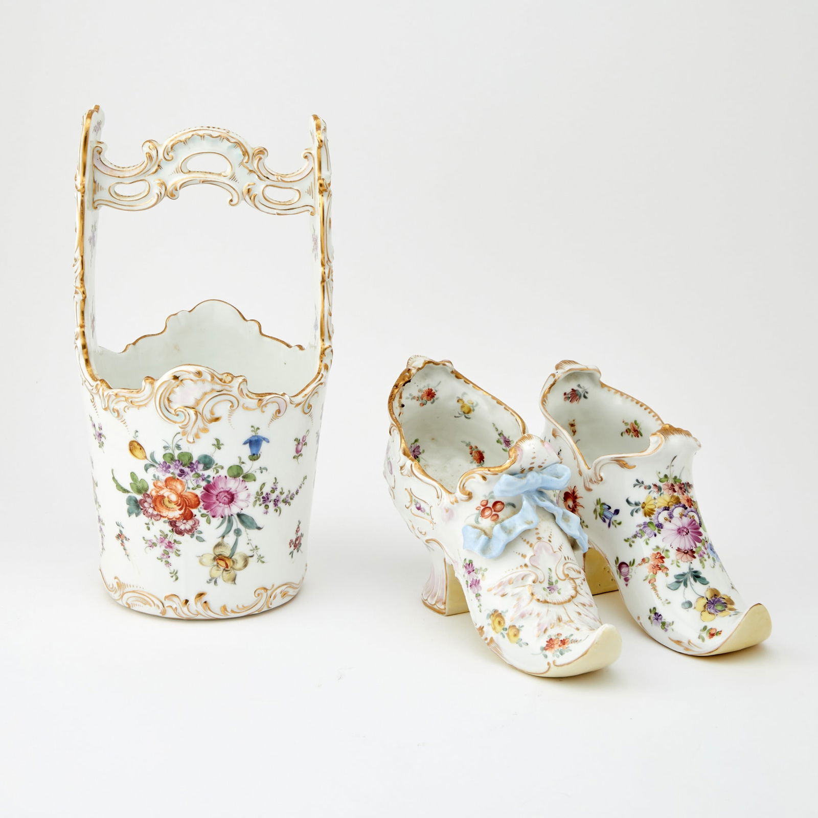 Two Dresden Porcelain Shoes with a Dresden Style Water Bucket Late 19th Century: The bucket: Height 11 1/2 inches, diameter 6 inches. Good condition.